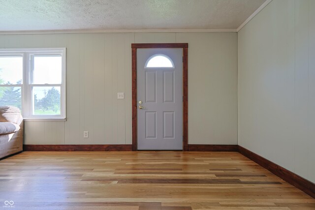 9855 N State Highway 7, Elizabethtown, IN 47232 - entryway featuring baseboards, ornamental molding, light wood-style flooring, and a textured ceiling