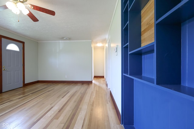 9855 N State Highway 7, Elizabethtown, IN 47232 - foyer entrance featuring a textured ceiling, light wood-type flooring, a ceiling fan, baseboards, and crown molding