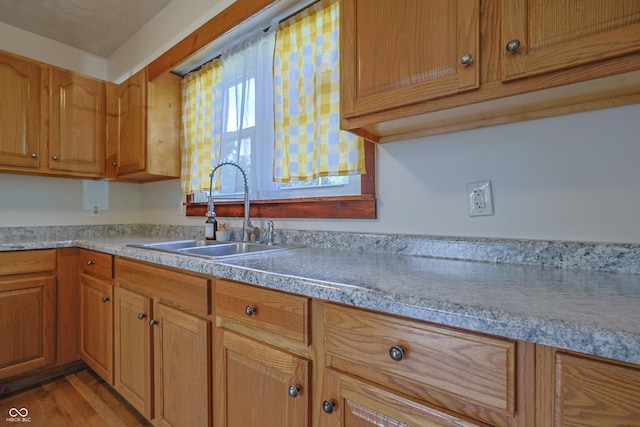 9855 N State Highway 7, Elizabethtown, IN 47232 - kitchen with a sink, light countertops, brown cabinetry, and light wood-style floors