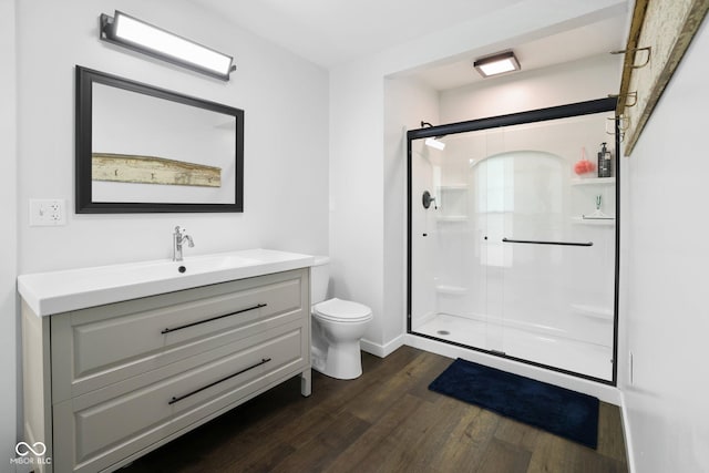 6673 Karyn Dr, Avon, IN 46123 - full bathroom with wood finished floors, toilet, a stall shower, vanity, and baseboards