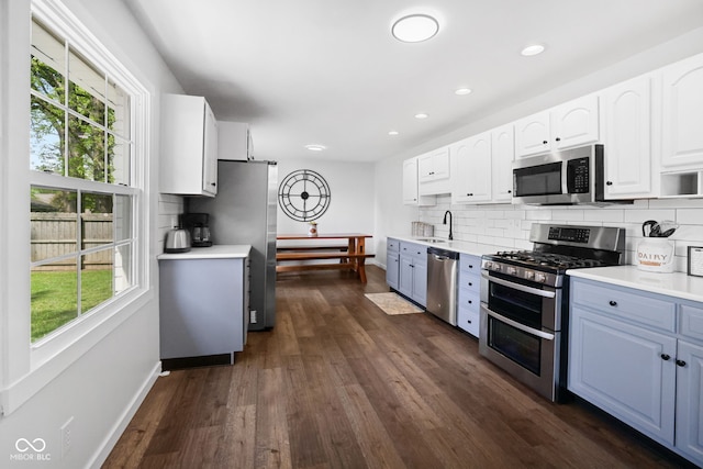6673 Karyn Dr, Avon, IN 46123 - kitchen featuring appliances with stainless steel finishes, a sink, decorative backsplash, white cabinetry, and recessed lighting