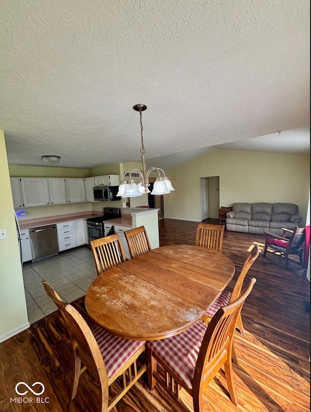 dining area featuring a textured ceiling and a chandelier