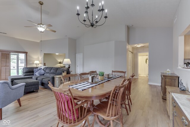 dining space featuring light wood-style floors, high vaulted ceiling, and ceiling fan