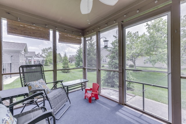 sunroom / solarium featuring ceiling fan
