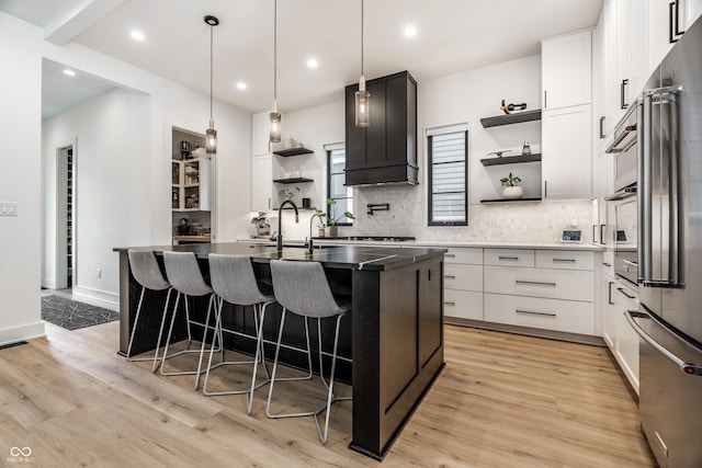 2036 Central Ave, Indianapolis, IN 46202 - kitchen featuring open shelves, custom exhaust hood, decorative backsplash, light wood-style floors, and recessed lighting