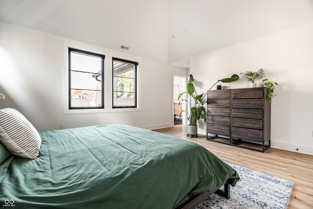 2036 Central Ave, Indianapolis, IN 46202 - bedroom with wood finished floors, baseboards, and a towering ceiling