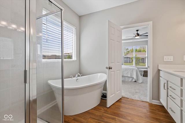 5375 Citadel Dr, Noblesville, IN 46062 - full bath with wood finished floors, a stall shower, a freestanding tub, vanity, and ceiling fan