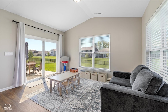 5375 Citadel Dr, Noblesville, IN 46062 - living room featuring wood finished floors, vaulted ceiling, plenty of natural light, and baseboards