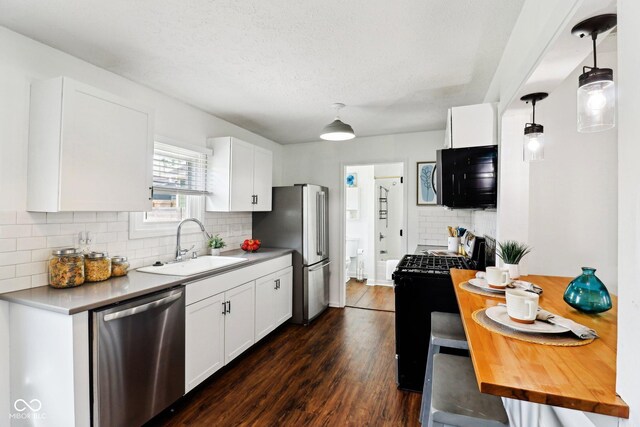 253 E Minnesota St, Indianapolis, IN 46225 - kitchen featuring appliances with stainless steel finishes, a sink, light countertops, tasteful backsplash, and white cabinetry