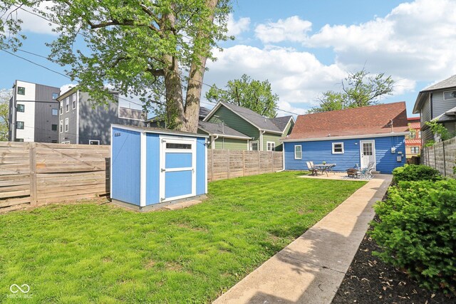 253 E Minnesota St, Indianapolis, IN 46225 - view of yard featuring a storage shed, an outbuilding, and a patio area