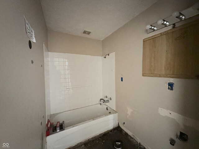 full bath featuring shower / tub combination and baseboards