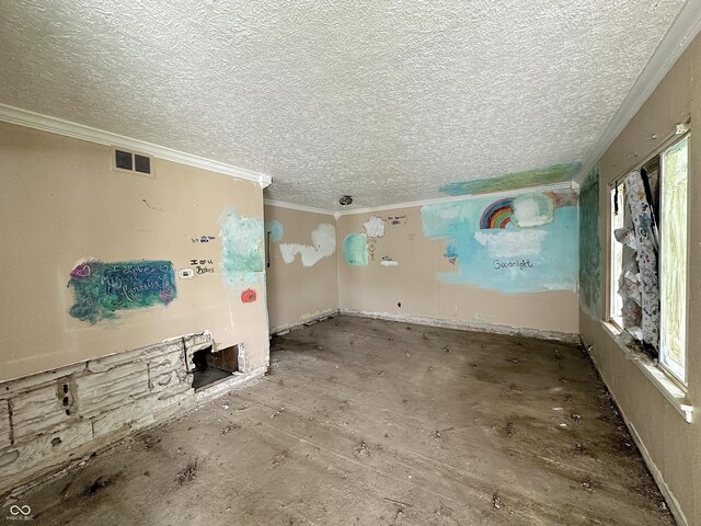spare room with a textured ceiling and crown molding