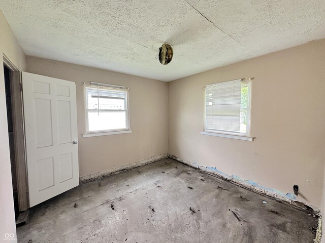 unfurnished bedroom with a textured ceiling