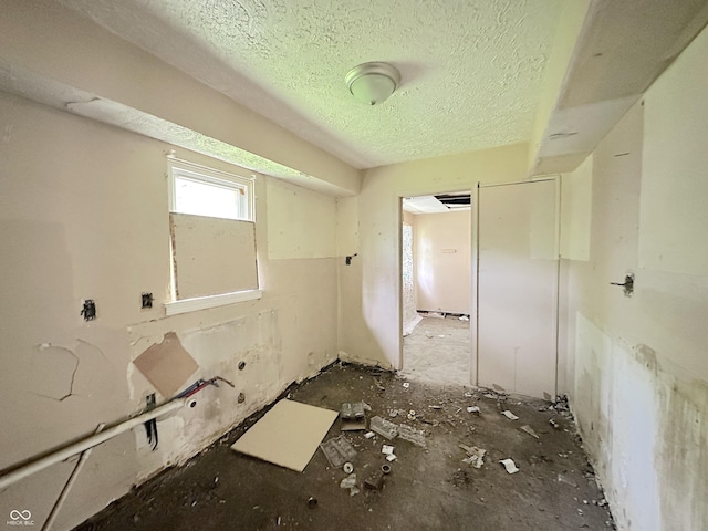 unfurnished room with a textured ceiling