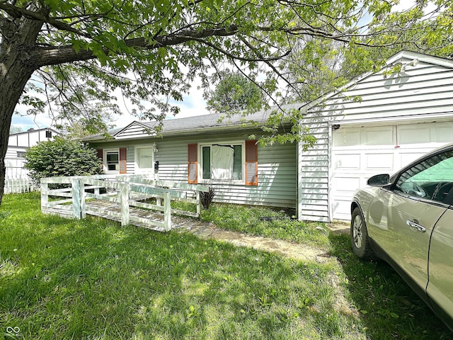 single story home with a garage and a front lawn