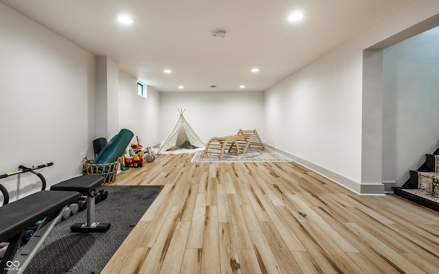 workout area with recessed lighting, wood finished floors, and baseboards