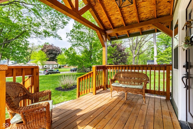 wooden deck with a lawn