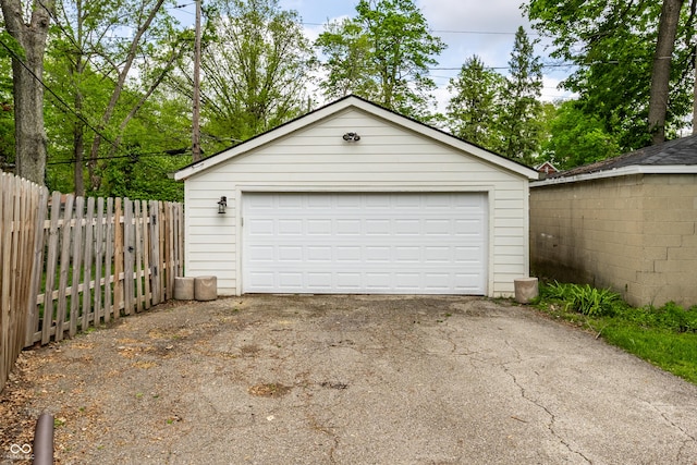 detached garage featuring fence