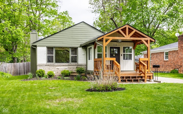 bungalow featuring a chimney and stone siding