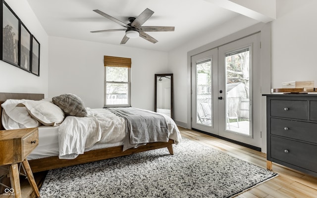 bedroom featuring french doors, access to exterior, light wood-type flooring, and a ceiling fan