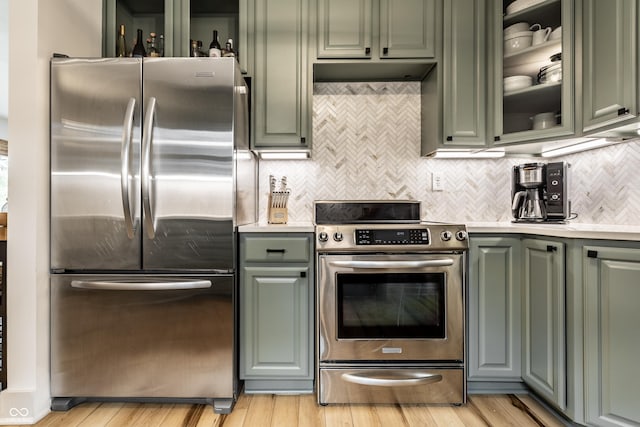 kitchen featuring appliances with stainless steel finishes, green cabinets, and light countertops