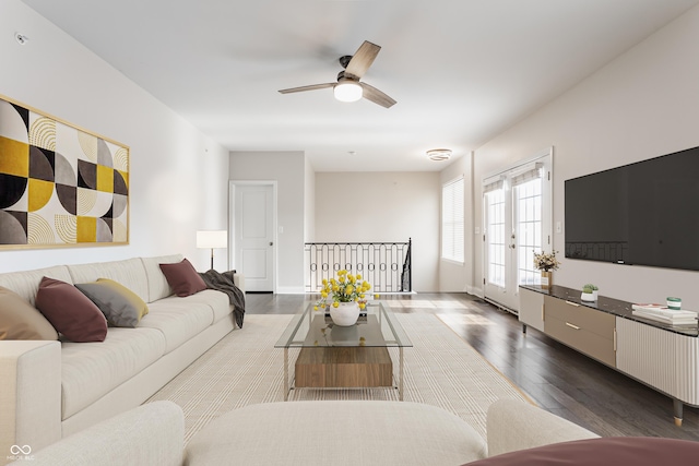 living area featuring dark wood-style flooring and a ceiling fan