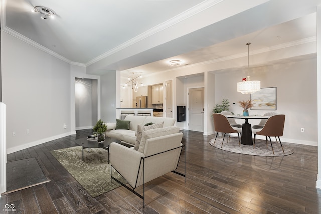 living area with dark wood-style floors, crown molding, baseboards, and a chandelier