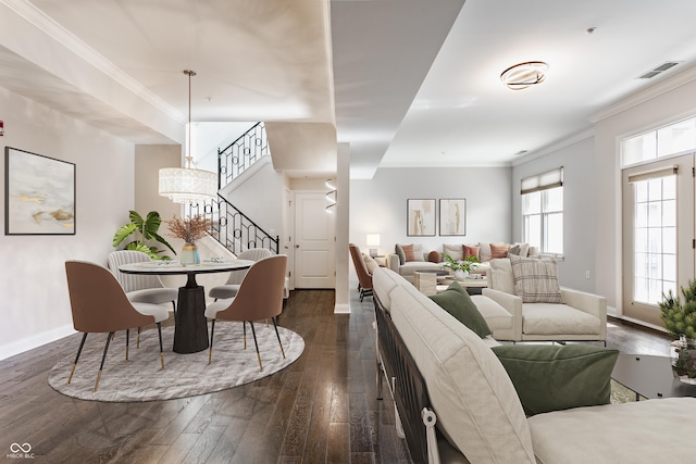 living room with dark wood-type flooring, stairs, baseboards, and ornamental molding