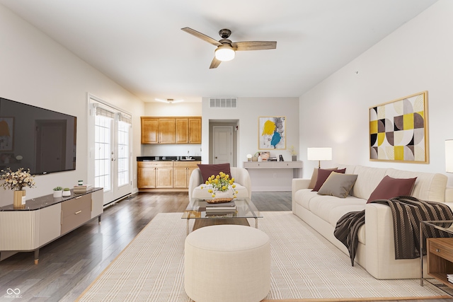 living room with wood finished floors and a ceiling fan
