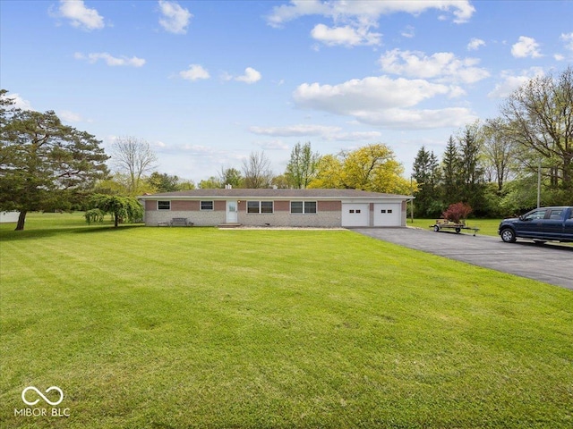 single story home with driveway, a front yard, and an attached garage