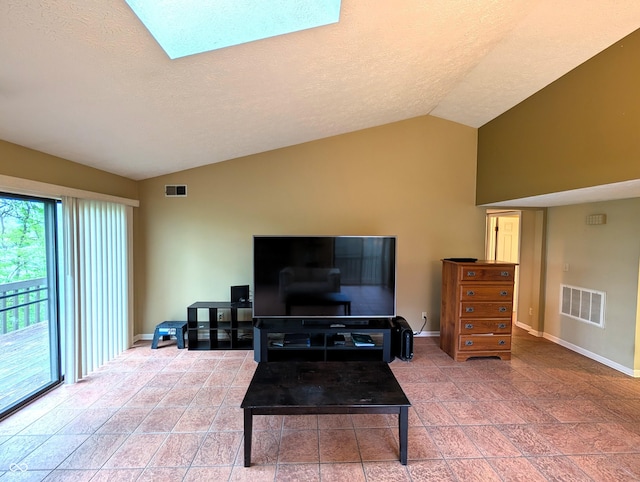 living area featuring lofted ceiling, baseboards, and a textured ceiling