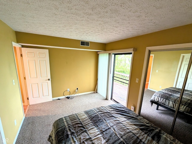 carpeted bedroom featuring access to outside, baseboards, and a textured ceiling
