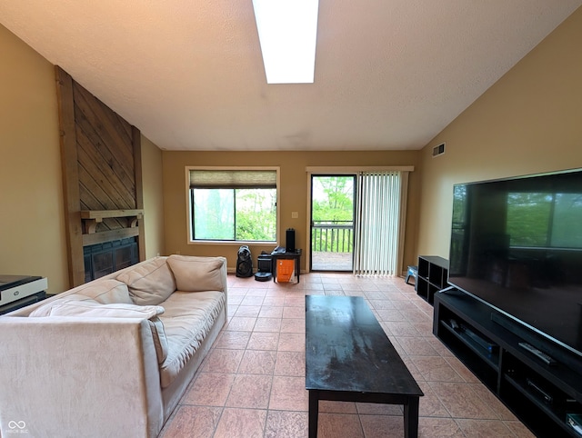 tiled living room with a large fireplace and lofted ceiling