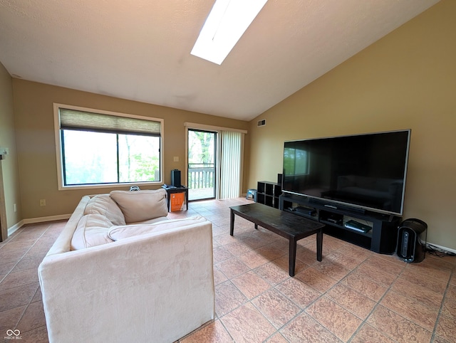 living area with a skylight, lofted ceiling, baseboards, and light tile patterned floors