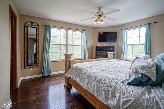 bedroom with dark wood finished floors, baseboards, and ceiling fan