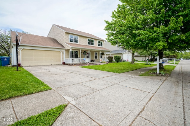 view of front of house featuring a porch, driveway, an attached garage, and a front yard
