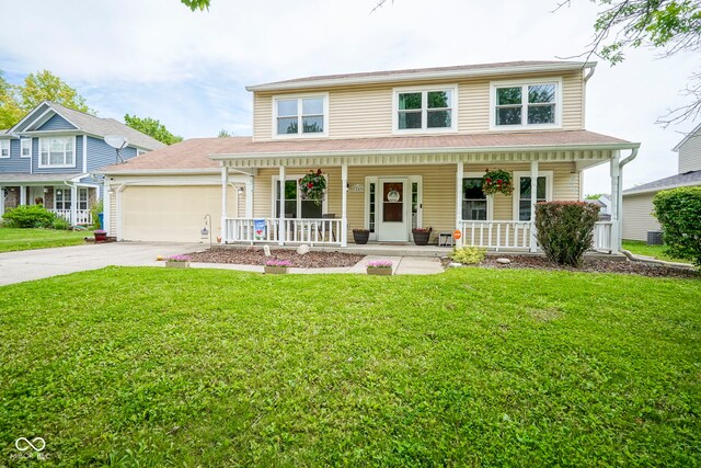 view of front of house featuring covered porch, a garage, driveway, and a front yard