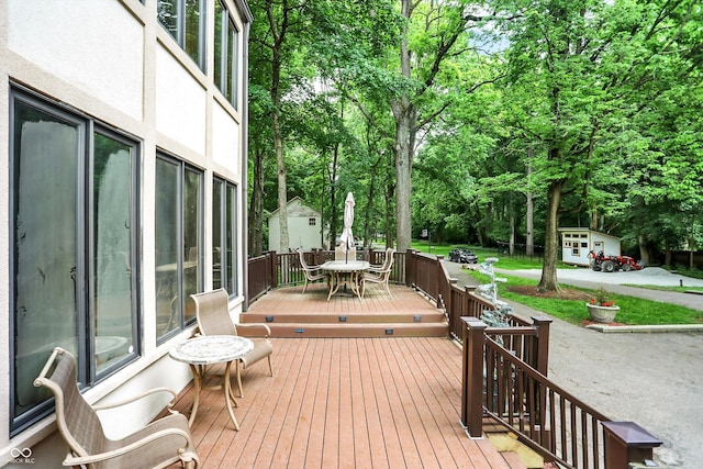 1530 E 75th St, Indianapolis, IN 46240 - deck featuring outdoor dining area and view of wooded area