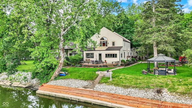 1530 E 75th St, Indianapolis, IN 46240 - back of house with a gazebo, stucco siding, a lawn, and a water view