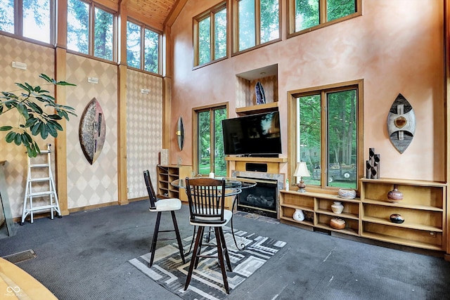 1530 E 75th St, Indianapolis, IN 46240 - carpeted dining space featuring high vaulted ceiling, baseboards, a glass covered fireplace, and wooden ceiling