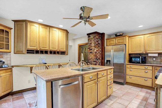 1530 E 75th St, Indianapolis, IN 46240 - kitchen with appliances with stainless steel finishes, a ceiling fan, decorative backsplash, a center island with sink, and recessed lighting