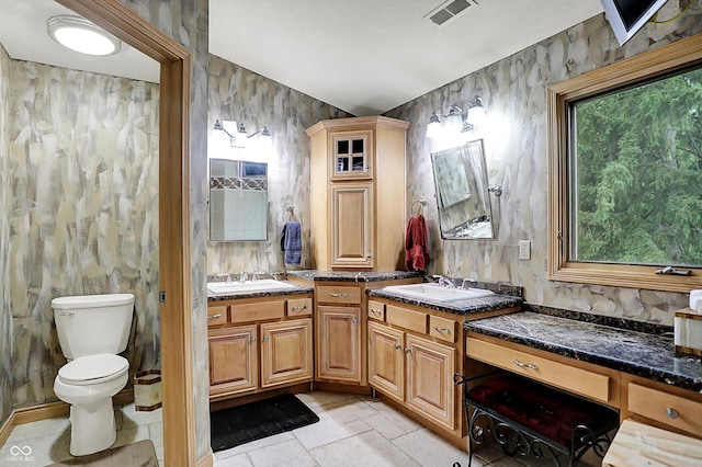 1530 E 75th St, Indianapolis, IN 46240 - full bathroom featuring double vanity, toilet, and wallpapered walls