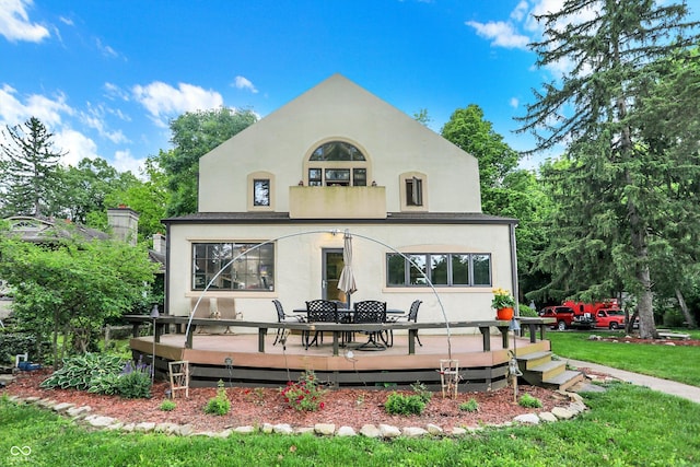 1530 E 75th St, Indianapolis, IN 46240 - rear view of property featuring stucco siding, a wooden deck, a lawn, and outdoor dining space