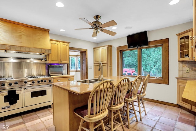 1530 E 75th St, Indianapolis, IN 46240 - kitchen featuring range with two ovens, a sink, backsplash, ceiling fan, and light brown cabinetry