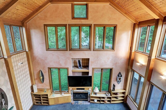 1530 E 75th St, Indianapolis, IN 46240 - carpeted living area with wood ceiling with exposed beams, a glass covered fireplace, and high vaulted ceiling