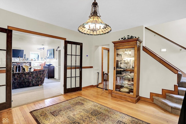 1530 E 75th St, Indianapolis, IN 46240 - entrance foyer with a chandelier, hardwood / wood-style flooring, stairs, french doors, and baseboards