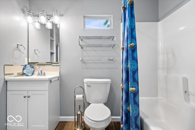744 Gilbert Ave, Indianapolis, IN 46227 - bathroom with toilet, baseboards, vanity, tasteful backsplash, and wood finished floors