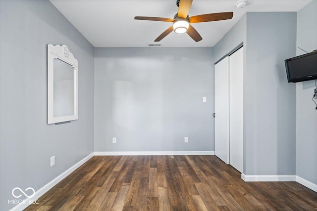 744 Gilbert Ave, Indianapolis, IN 46227 - unfurnished bedroom with baseboards, wood finished floors, a closet, and a ceiling fan
