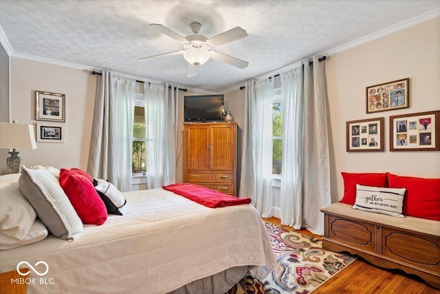 744 Gilbert Ave, Indianapolis, IN 46227 - bedroom with ornamental molding, wood finished floors, a textured ceiling, and a ceiling fan