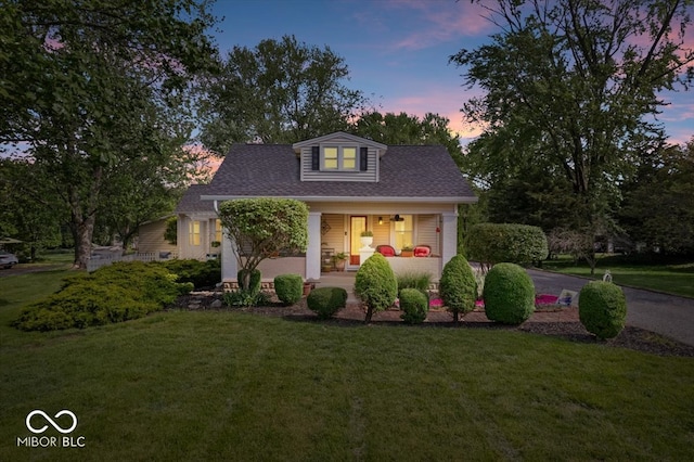 744 Gilbert Ave, Indianapolis, IN 46227 - bungalow-style home featuring a porch, a lawn, and a shingled roof